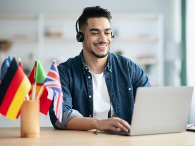 Happy arab guy student learning foreign language online