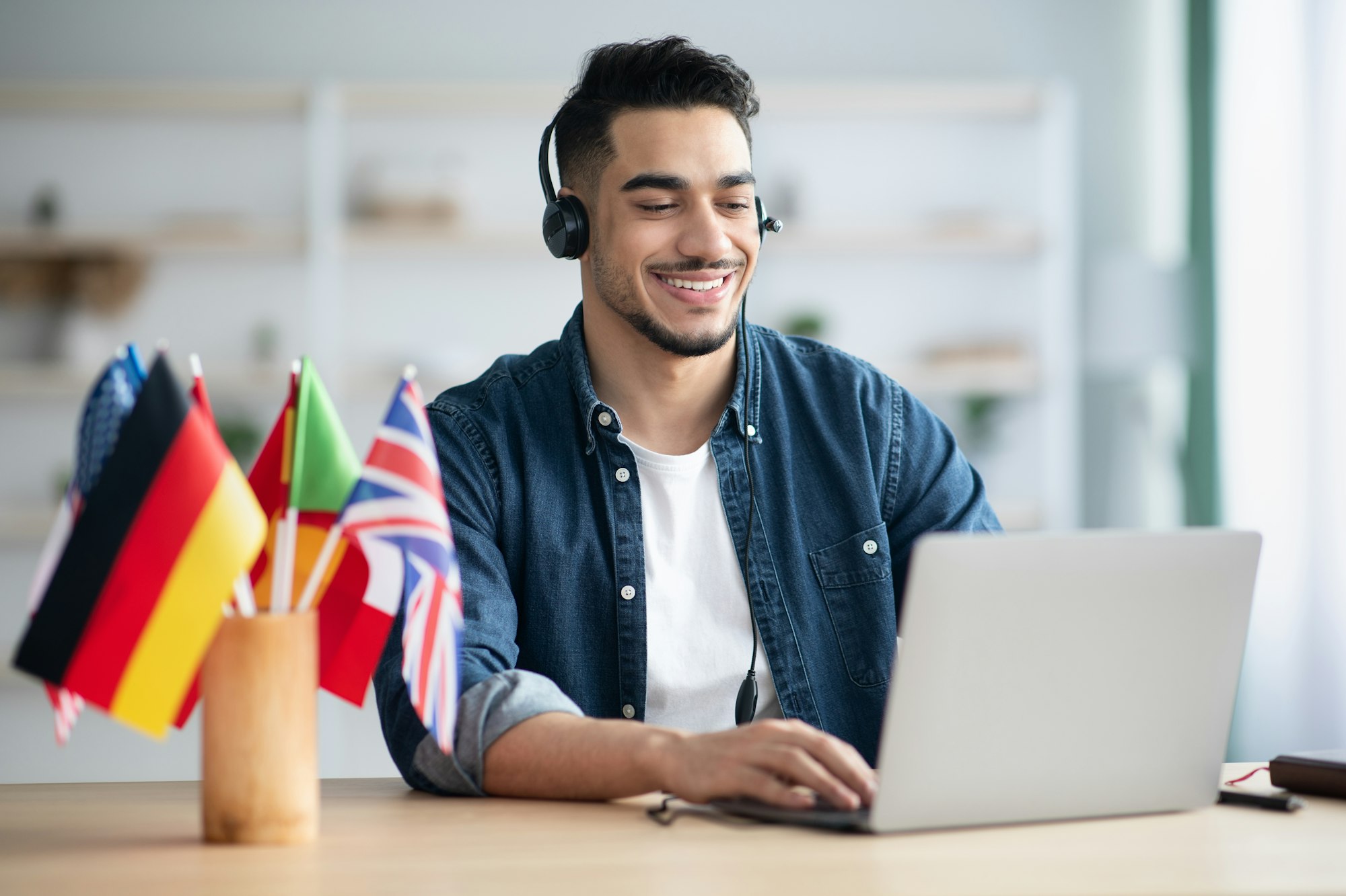 Happy arab guy student learning foreign language online